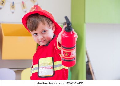 Caucasian Boy Kid Dress Up To Fireman And Use Speaker At Roll Play Classroom,Kindergarten Preschool Education Concept.