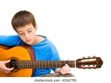 caucasian boy learning to play acoustic guitar, isolated on white background; horizontal crop - Powered by Shutterstock