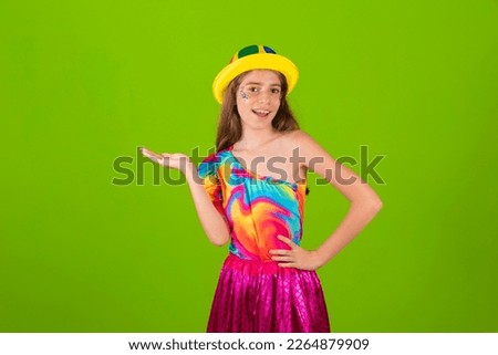 caucasian, brazilian girl dressed for carnival. welcome, pointing to the side, negative space, presenting product.