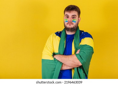 Caucasian Brazilian Man, Brazil Soccer Fan, Arms Crossed, Wearing Brazil Flag Cape.