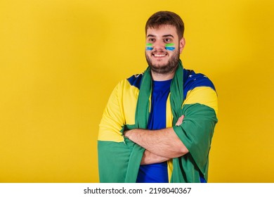 Caucasian Brazilian Man, Brazil Soccer Fan, Arms Crossed, Wearing Brazil Flag Cape.