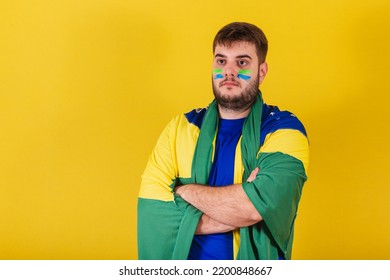 Caucasian Brazilian Man, Brazil Soccer Fan, Arms Crossed, Wearing Brazil Flag Cape.