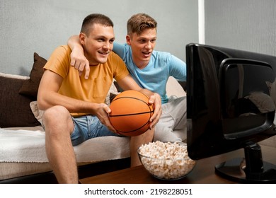 Caucasian Brothers Or Friends Watching Basketball Game On Tv Together 