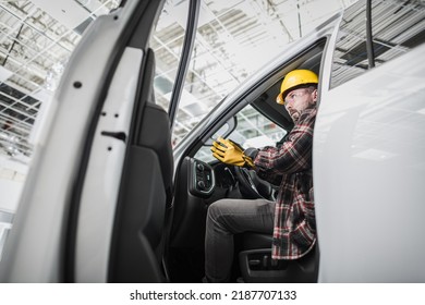 Caucasian Building Supervisor At His 30s Getting Off The Van At The Construction Site Inside The Large Hall Wearing The Safety Helmet. Ready And Determined To Check The Quality Of The Work Done.