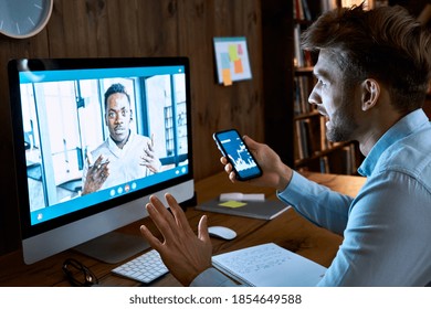 Caucasian Business Man Financial Advisor, Stock Trader, Broker Consulting African Client Investor About Investment On Video Conference Call Virtual Remote Meeting Chat Using Pc Computer And Phone App.