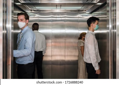 Caucasian Business Man And Other People Standing Apart From Each In Corner Of Elevator For Social Distancing To Avoid Coronavirus Covid-19 Spreading, Selective Focus