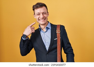 Caucasian Business Man Over Yellow Background Smiling Cheerful Showing And Pointing With Fingers Teeth And Mouth. Dental Health Concept. 