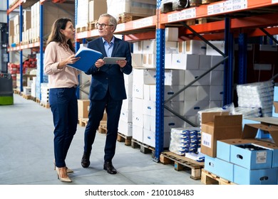 Caucasian Business Mature Man And Woman In The Warehouse                              