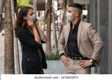 Caucasian Business People Wearing Medical Mask For Coronavirus Covid 19 Protection Standing Together Beside Office Building And Talking In City, Working In Coronavirus Covid 19 Pandemic Situation