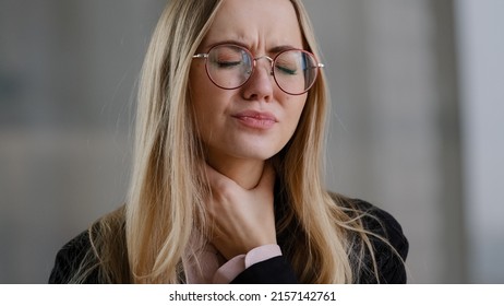 Caucasian business woman girl in glasses worker manager holding throat indoors feels discomfort sore throat respiratory disease covid symptom panic attack suffocation lack of air suffering from asthma