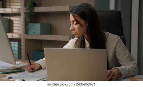 Caucasian business woman multitasking busy in office working online with laptop talking mobile phone smartphone writing documents papers answer call talk with clients multitask businesswoman work - Powered by Shutterstock