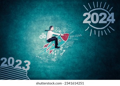 Caucasian businessman flying toward 2023 new year numbers with a rocket in blackboard background - Powered by Shutterstock