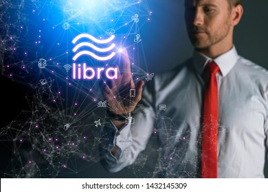 caucasian businessman hand touch virtual hologram of libra newest crypto currency from facebook business technology ideas cocnept - Shutterstock ID 1432145309