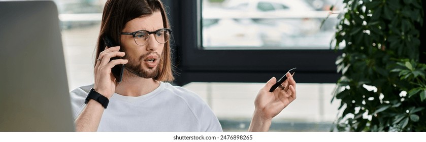 Caucasian businessman multitasking, talking on cell phone while utilizing laptop. - Powered by Shutterstock