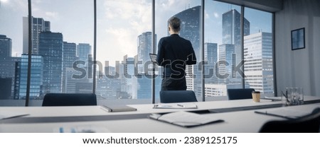 Caucasian Businessman Walking Into Corner Office With Megapolis City View, Holding Laptop Computer. Professional CEO Standing Infront Of Big Window And Thinking About Opportunities.