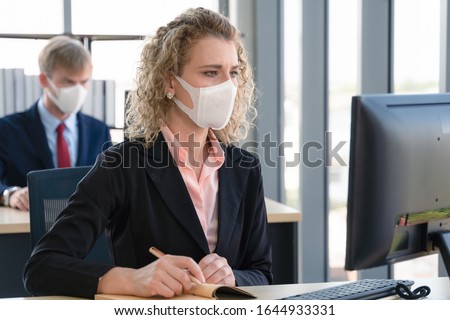 caucasian businesspeople with medical mask for coronavirus covid-19 protection working in office, new normal business practise of coronavirus covid-19 outbreak control