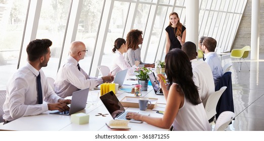 Caucasian Businesswoman Leading Meeting At Boardroom Table