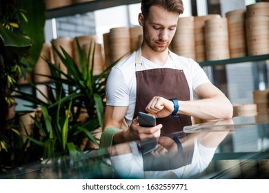 Caucasian Calm Man Checking Time During His Working Day. Work And Business Concept