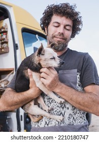 Caucasian Camper Van Nomad Holding His Old Small Dog Friend