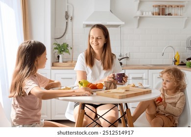 Caucasian caring and loving cheerful mom serving a nutritious lunch together with her hungry toddlers who sitting at the table in home family smiling with delight and enjoying breakfast time - Powered by Shutterstock