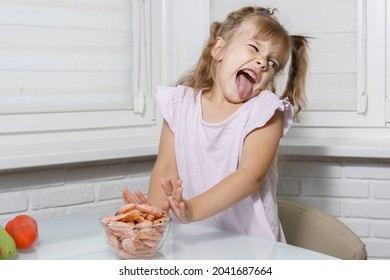 Caucasian Child Girl Refuses To Eat Shrimp. A Kid Not Hungry, Hate Fish, Seafood. Refusing To Eat