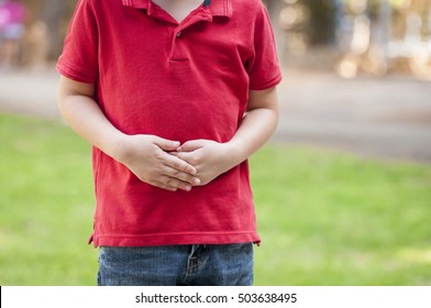 Caucasian Child With Stomach Ache, Boy Holding His Hands On His Belly.