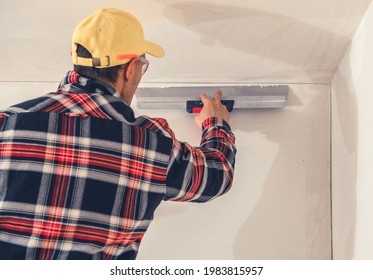 Caucasian Construction Finishing Worker In His 40s Patching Drywall