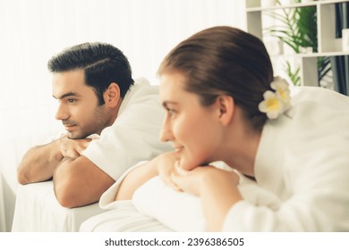 Caucasian couple customer enjoying relaxing anti-stress spa massage and pampering with beauty skin recreation leisure in day light ambient salon spa at luxury resort or hotel. Quiescent - Shutterstock ID 2396386505