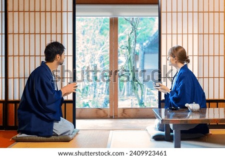 caucasian couple  drinking tea in tipical house  in Japan