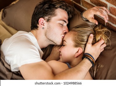 Caucasian couple lying on bed together - Powered by Shutterstock