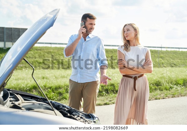 Caucasian couple need\
a help with broken car\
