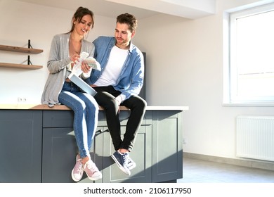 Caucasian Couple In New Kitchen Holding Paint Palette To Discuss