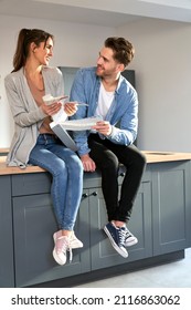 Caucasian Couple In New Kitchen Holding Paint Palette To Discuss