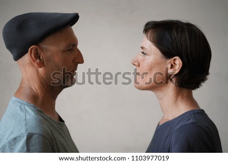 Similar – Man and woman face each other