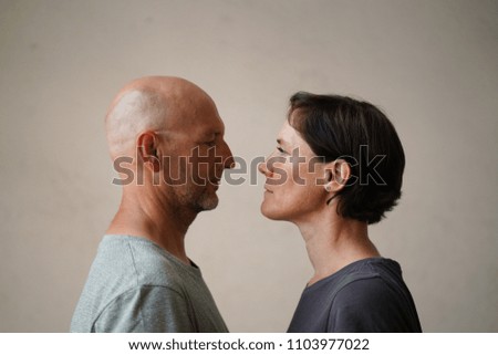 Similar – Man and woman face each other