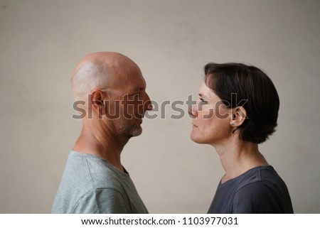 Similar – Man and woman face each other