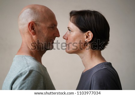 Similar – Man and woman face each other