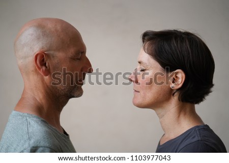 Similar – Man and woman face each other