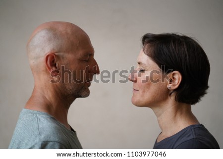 Similar – Man and woman face each other