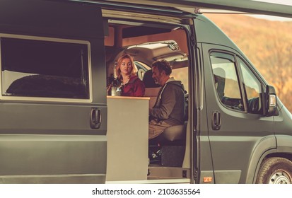 Caucasian Couple Traveling In Their Own Made Recreational Vehicle RV  Class B. Van Life Theme. 