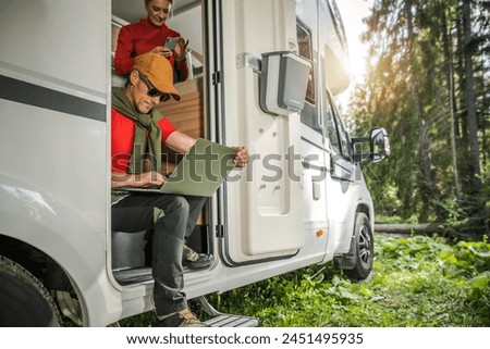 Caucasian Couple Using Internet While Traveling in a Camper Van