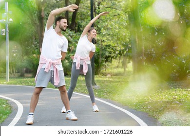 Caucasian Couples Exercising Outdoor Or Park In The Morning. Daily Workout Will Keep Your Body Healthy. Lifestyle In The New Normal Style Of Modern People. Concept Social Distancing.