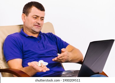 Caucasian Deaf Man With Hearing Impairment Holds A Hearing Aid In His Hand And Shows It To The Laptop Camera. ASL Conversation Online