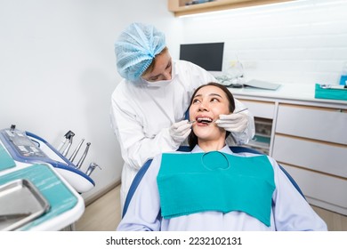 Caucasian dentist examine tooth for young girl at dental health clinic. Attractive woman patient lying on dental chair get dental treatment from doctor during procedure appointment service in hospital - Powered by Shutterstock