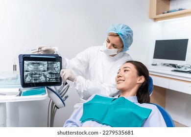 Caucasian dentist examine tooth for young girl at dental health clinic. Attractive woman patient lying on dental chair get dental treatment from doctor during procedure appointment service in hospital - Powered by Shutterstock