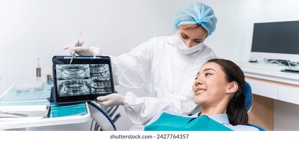 Caucasian dentist examine tooth for young girl at dental health clinic. Attractive woman patient lying on dental chair get dental treatment from doctor during procedure appointment service in hospital - Powered by Shutterstock