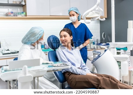 Caucasian dentist examine tooth for young girl at dental health clinic. Attractive woman patient lying on dental chair get dental treatment from doctor during procedure appointment service in hospital