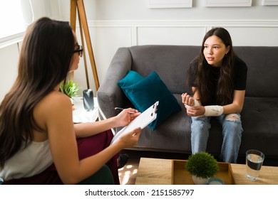 Caucasian Depressed Teenage Girl Asking For Help To A Female Psychologist After A Suicide Attempt