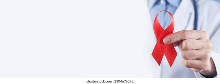 Caucasian doctor holds a red ribbon. - Powered by Shutterstock