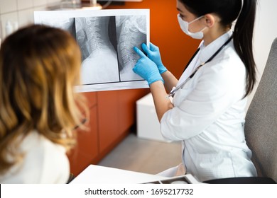 Caucasian Doctor Pointing With Index Finger Scoliosis Of Kid Stock Photo. Pediatrics Concept